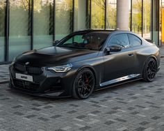 a black car parked in front of a building