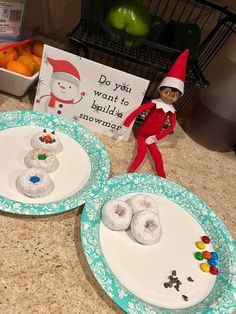 two plates with doughnuts on them and an elf next to the plate that says do you want to build snowmen?