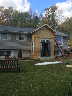 a house being built in the fall with a ladder leaning against it's wall