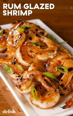 grilled shrimp served on a white plate with green garnish and text that reads, rum glazed shrimp