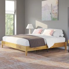 a bed sitting on top of a hard wood floor next to a window in a bedroom