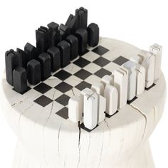 a chess board with black and white pieces arranged on it's sides, in front of a white background