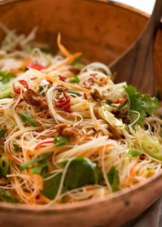 a wooden bowl filled with lots of food