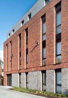 a brick building with many windows on the side