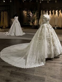 wedding gowns are displayed on mannequins in a bridal shop