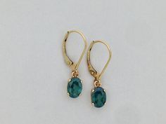 "SOLID 14KT YELLOW GOLD EARRINGS NATURAL CARIBBEAN TOPAZ IS 7x5 mm OVAL SHAPE EACH EARRING LENGTH IS 1\" INCH COMES IN GIFT BOX" Pear-shaped Green Gemstone Earrings, Green 14k Gold-filled Dangle Earrings, Topaz Earrings, Yellow Gold Earring, Gold Earrings Dangle, Fine Jewellery Earrings, Elegant Jewelry, Topaz, Gold Earrings