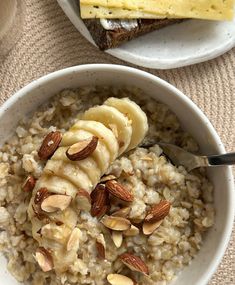 two bowls of oatmeal with bananas and almonds on the top one bowl is filled with nuts