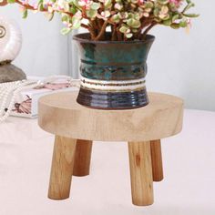 a potted plant sitting on top of a wooden stool