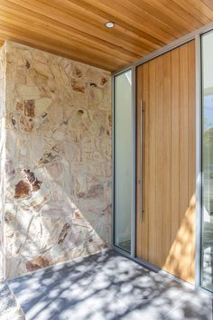 a stone building with wood and glass doors