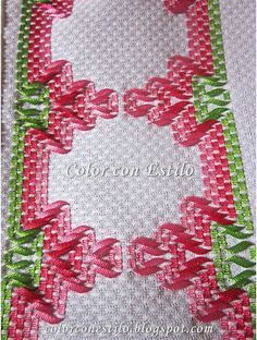 some pink and green ribbon on a white background