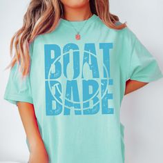 Hey there, Boat Babe! Are you ready to sail through life in style? Introducing our "Boat Babe" Comfort Color Tee – the perfect blend of nautical charm and laid-back comfort! Crafted from premium Comfort Color fabric, this tee feels as soft as a sea breeze against your skin. The playful "Boat Babe" graphic celebrates your love for all things maritime, whether you're out on the water or lounging on the shore. Whether you're setting sail on a yacht or simply daydreaming about your next seaside adve Summer Boating T-shirt With Crew Neck, Summer Crew Neck T-shirt For Boating, Summer Boating T-shirt With Short Sleeves, Summer Short Sleeve T-shirt For Boating, Nautical Cotton Tops For The Beach, Nautical Blue Top For Beach, Blue Cotton Tops For Boating, Nautical Cotton Top For Boating, Nautical Cotton Tops For Boating