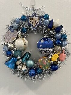 a christmas ornament hanging on the wall with ornaments around it and a hanukkah menorah in the middle