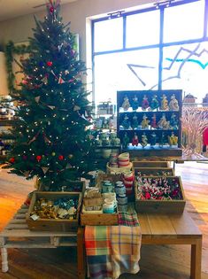 a christmas tree is in the middle of a room with many ornaments on it and other decorations