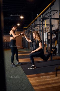 two women in the gym doing squats with each other - stock photo - images