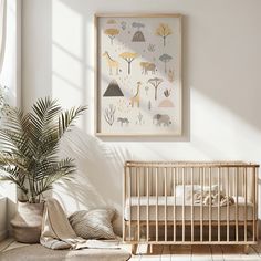 a baby's room with a crib, plant and pictures on the wall