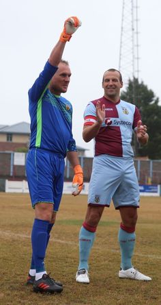 two men standing on top of a soccer field