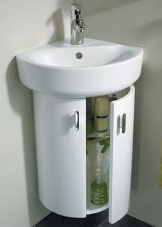 a white sink sitting under a bathroom mirror