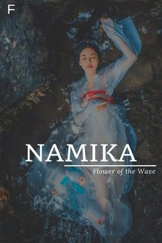 a woman in a blue dress sitting on rocks with the caption namika flower of the water