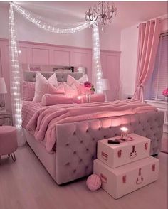 a bedroom with pink decor and lights on the ceiling