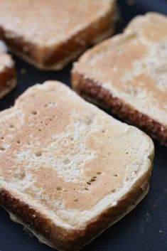 four pieces of toasted bread on a blue plate