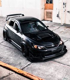 a black car parked in front of a building