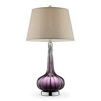 a purple glass lamp with a beige shade