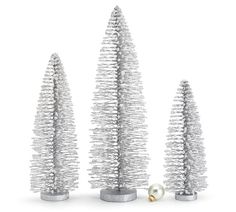 three silver christmas trees and a pearl ornament on a white background with clippings