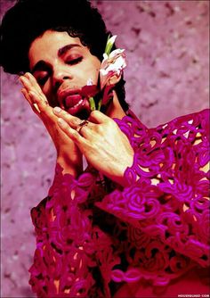 a woman holding a flower in her hands