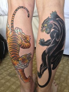 two people with tattoos on their legs and one has a tiger and the other is a tiger