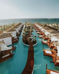 an outdoor swimming pool next to the ocean