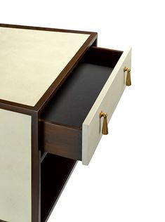 a white and brown table with two drawers on each side, one drawer open to show the contents