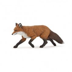 a toy fox walking across a white surface