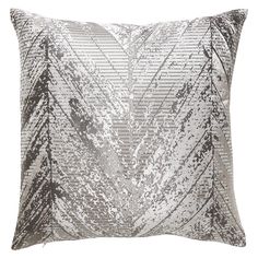 a silver and black pillow with metallic sequins on the front, along with a white background