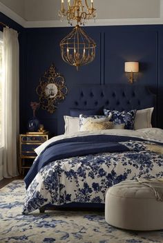 a blue and white bedroom with a chandelier