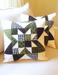 two pillows are sitting on a couch with the same pattern as they appear to be made