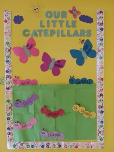 a bulletin board with butterflies and hand prints on it that says our little caterpillars