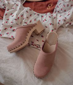 Made by skilled artisans in Sweden, these blush pink nubuck clog mules feature a high heel and eye-catching stud detailing on the sides. From date nights to ladies' nights out, Rome delivers unparalleled style and confidence. Clog measurements:Heel height: 2 5/8” (6.5 cm)Toe height:﻿ 1 1/2″ (3.8 cm) Fit:NarrowLeather:Nubuck leatherClogs consist of:Base: European Lime Wood Sole: Rubber sole Fastening: Brass studs Suede Open Heel Clogs For Spring, Pink Leather Sole Mules For Spring, Pink Mules With Leather Sole For Spring, Spring High Heel Clogs With Studded Rubber Outsoles, Spring Suede Clogs With Block Heel, Pink Mules With Wooden Heel And Round Toe, Pink Mules With Wooden Heel For Spring, Chic Suede Clogs With Wooden Heel, Pink Open Heel Clogs For Spring