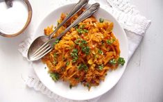 a white plate topped with carrots and parsley