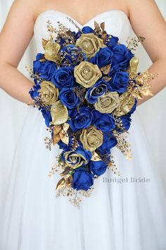 a bride holding a blue and gold bouquet