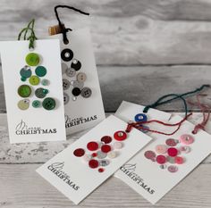 three christmas cards with buttons on them