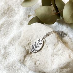 This delicate and tender pendant featuring a twig with leaves is entirely handcrafted from high-quality silver. It is a wonderful gift for nature and houseplant lovers. The pendant comes with a 50 cm chain. Sterling Silver Everyday Necklace With Nature-inspired Style, Everyday Silver Necklace With Nature-inspired Style, Silver Nature-inspired Necklace For Everyday, Everyday Nature-inspired Silver Necklace, Everyday Silver Nature-inspired Necklace, Minimalist Silver Charm Necklace With Birth Flower, Everyday Nature-inspired Sterling Silver Necklace, Minimalist Silver Birth Flower Charm Necklace, Minimalist Sterling Silver Leaf Jewelry