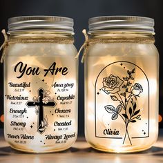 two mason jars with labels on them sitting next to each other, one has a cross and the other says you are beautiful