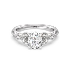 a white gold engagement ring with diamonds on it