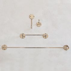 the handles and knobs are attached to the wall with two bars on each side