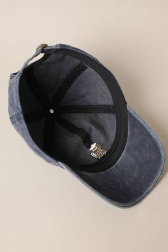 a black and blue hat laying on top of a white table