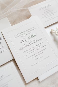 the wedding stationery is laid out on top of each other