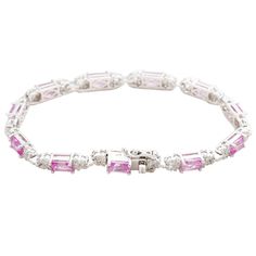 Timeless beauty, this Suzy Levian tennis bracelet will be the perfect finishing touch to your wardrobe all year round! 11 emerald-cut natural pink gemstones are linked an intricate design of pave set smaller round created white sapphires, all prong-set in a high polished 925 sterling silver. Perfectly stackable with any other Suzy Levian tennis bracelet this bracelet secures with a double side lock ensuring an easy, safe and secure fit the whole time it's locked on your wrist. Each Suzy Levian c It's Locked, Pink Gemstones, Pink Bracelet, White Sapphire, Intricate Design, Tennis Bracelet, Pink Sapphire, Emerald Cut, Timeless Beauty