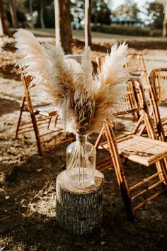 an arrangement of chairs and vases with feathers on them