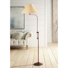 a floor lamp in a living room next to a couch