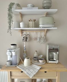 a kitchen counter with pots, pans and other items on it's shelves